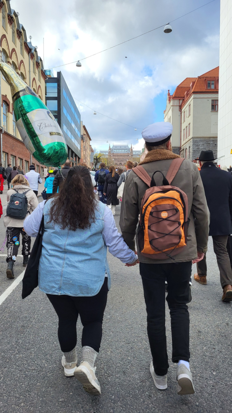 woman and man walking hand in hand outside